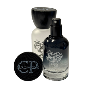 perfume bottles in black gradient and frosted white with crimped sprayers. 